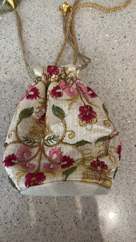 Handmade Indian embroidered potli bags featuring intricate floral designs.