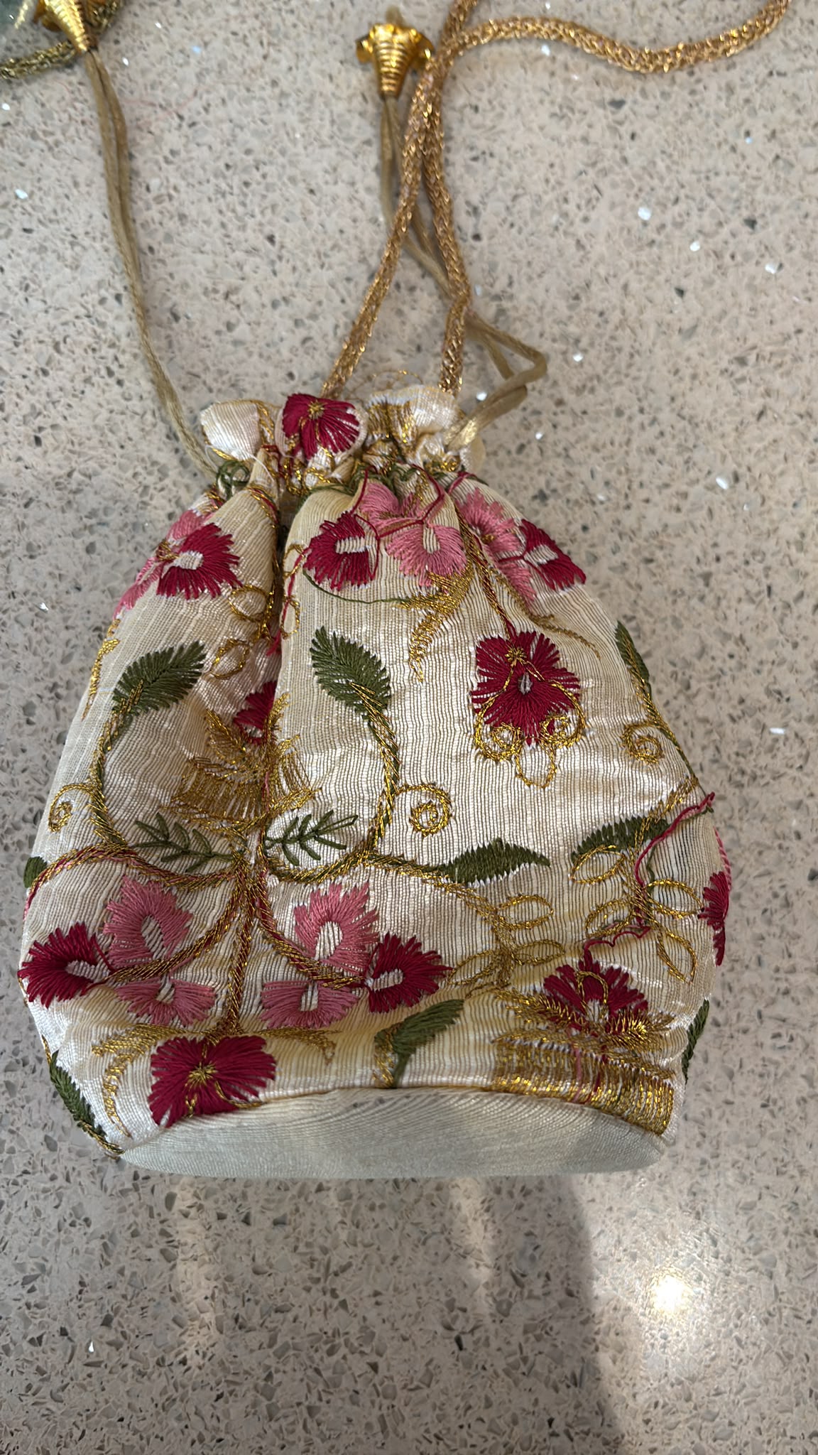 Handmade Indian embroidered potli bags featuring intricate floral designs.