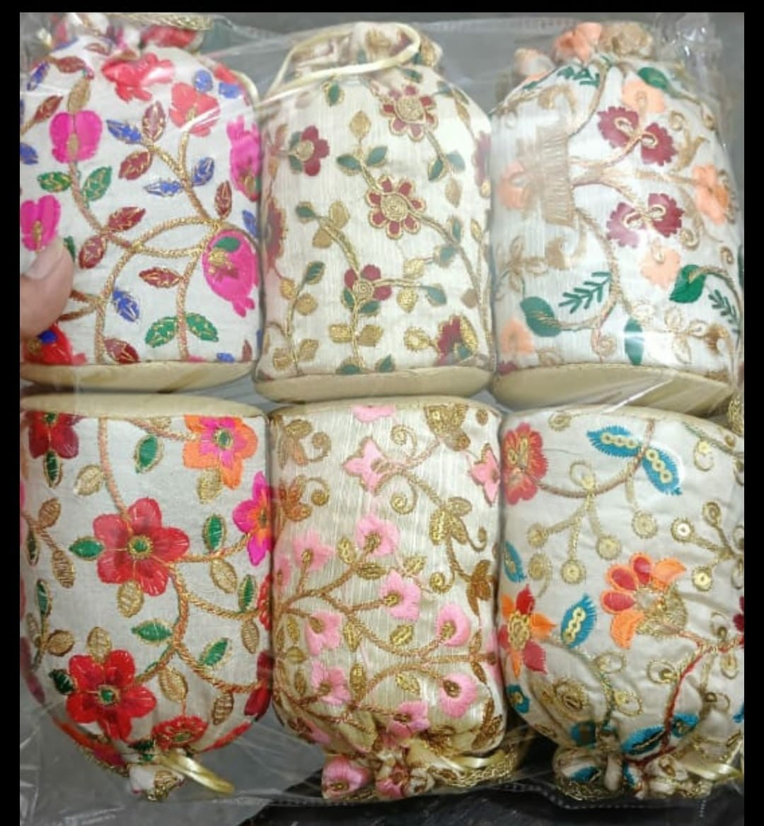 Handmade Indian embroidered potli bags featuring intricate floral designs.