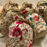 Handmade Indian embroidered potli bags featuring intricate floral designs.